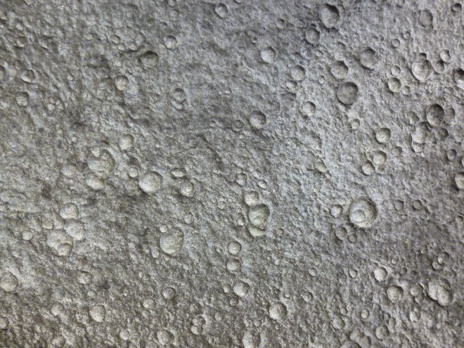 Handmade paper sculpted by falling rain close up