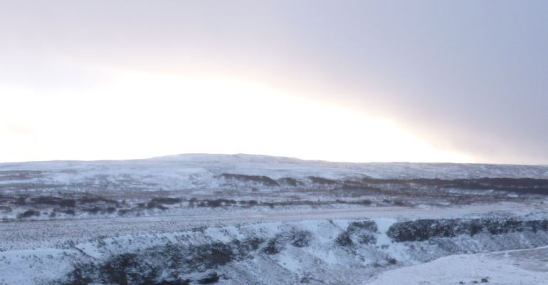 Iceland cr Judy Darley. A winter sunrise over a snowy landscape where everything is white, silver, blue and black