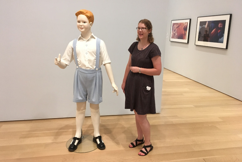 Making friends at the Art Institute of Chicago. Shows woman in an art gallery standing with outsize sculpture of child. Photo by James Hainsworth