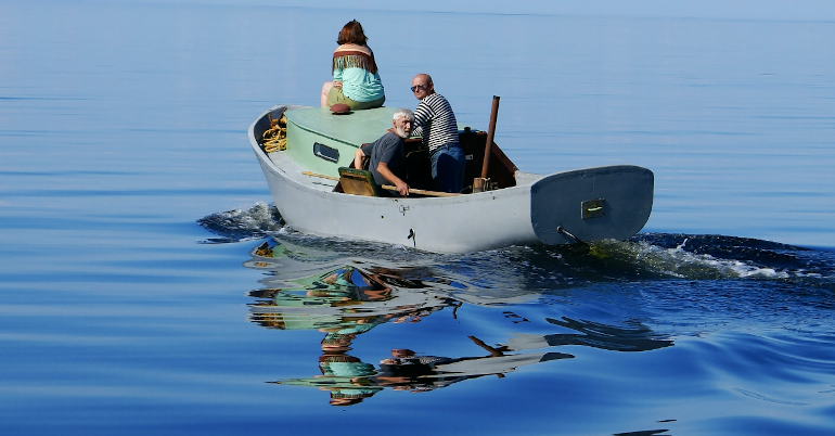 Three editors in a boat. Photo by Ivan Lapyrin on Unsplash